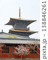 Traditional Pagoda Temple With Golden Roof and Pink Blossom Trees in Serene Spring Setting 138846261