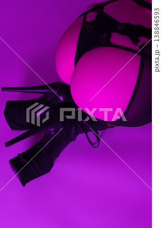 High angle view woman's buttocks in thong, garter belt, stockings, heels. Closeup woman low section High angle view woman's buttocks in thong, garter belt, stockings, heels. Closeup woman low section 138846593