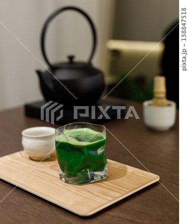 Cup of fresh matcha tea, green tea and Chasen, bamboo whisk, on wooden table. 138847518