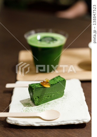 Closeup of fresh matcha terrine with cup of matcha on wooden background. Closeup of fresh matcha terrine with cup of matcha on wooden background. 138847523