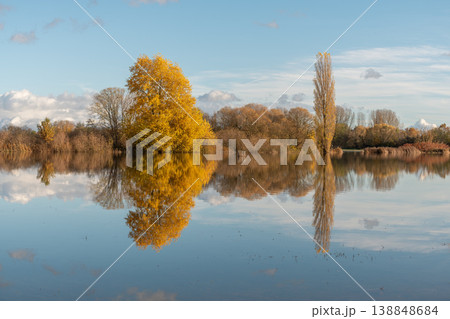River with clouds and mountains under blue sky floods plain in autumn 138848684