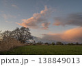 Landscape with clouds and trees under changing sky at end of day 138849013
