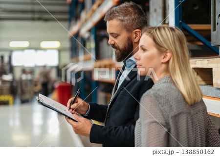 Industrial team evaluate the production process in high tech manufacturing plant. Industrial team evaluate the production process in high tech manufacturing plant. 138850162