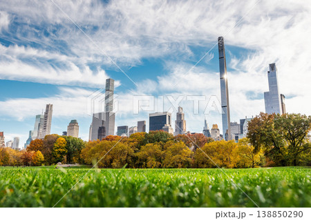 Low angle view of Central Park grass with Manhattan skyline and colorful autumn trees in New York City USA Low angle view of Central Park grass with Manhattan skyline and colorful autumn trees in New York City USA 138850290