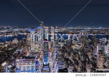 Night aerial view of Hudson Yards district and Manhattan skyline with illuminated modern skyscrapers and city lights in New York City USA Night aerial view of Hudson Yards district and Manhattan skyline with illuminated modern skyscrapers and city lights in New York City USA 138850307