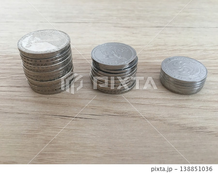 Three Stacks of Georgian Lari and Tetri Coins on Wooden Surface 138851036