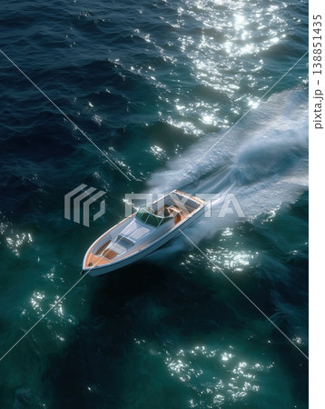 Luxury speedboat cutting through sparkling blue ocean water, leaving a white wake, symbolizing freedom, power, and high end summer recreation 138851435