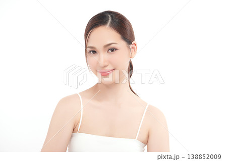 A beautiful young Asian woman with clean, fresh skin against a white background. Skincare, facial treatment, cosmetology, beauty, and spa. An elegant portrait of an Asian woman. 138852009