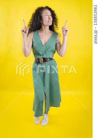 Woman pointing fingers up looking for idea 138852661