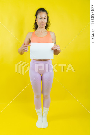 Woman holding blank sign pointing offering message space 138852677