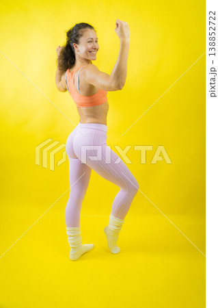 Woman flexing muscles celebrating fitness achievement Woman flexing muscles celebrating fitness achievement 138852722