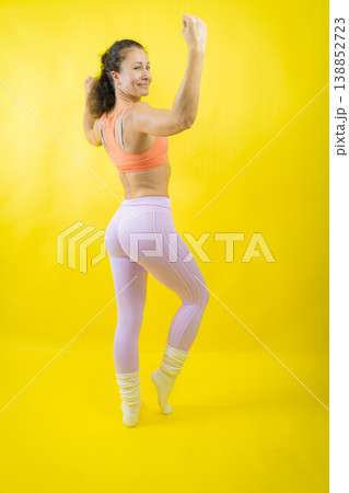Fit woman flexing arm muscles celebrating strength Fit woman flexing arm muscles celebrating strength 138852723