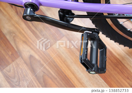Detailed view of a bicycle pedal with reflector and drivetrain components, emphasizing durability, motion, and modern cycling lifestyle. Detailed view of a bicycle pedal with reflector and drivetrain components, emphasizing durability, motion, and modern cycling lifestyle. 138852733