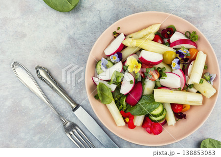 Colorful Vegetable Salad with Asparagus, Radishes and Edible Flowers on a Plate Colorful Vegetable Salad with Asparagus, Radishes and Edible Flowers on a Plate 138853083