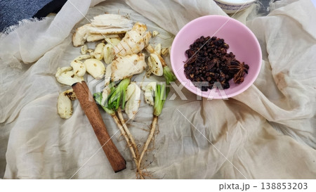 Aromatic Asian Spices with Ginger Garlic Cinnamon and Star Anise on White Cloth 138853203