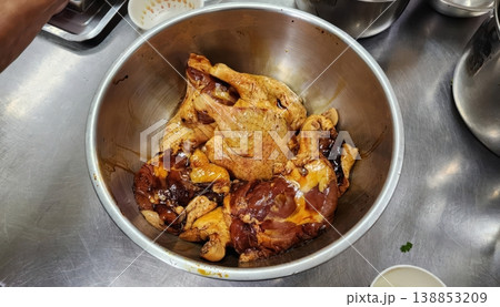Marinated Raw Duck Legs in a Stainless Steel Mixing Bowl for Asian Cuisine Cooking Marinated Raw Duck Legs in a Stainless Steel Mixing Bowl for Asian Cuisine Cooking 138853209