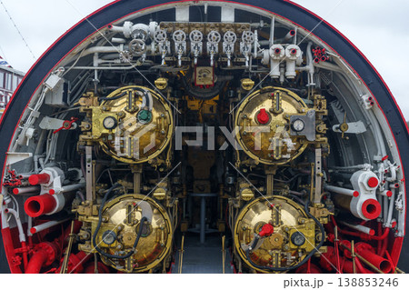 Submarine torpedo room with four brass torpedo tubes and mechanical control systems. Submarine torpedo room with four brass torpedo tubes and mechanical control systems. 138853246