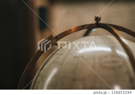 Vintage globe with meridian ring close-up, antique geographic instrument detail 138853294
