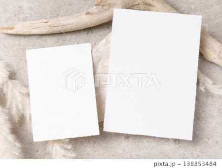 Blank wedding cards set mockup on beige stone with driftwood and pampas grass, boho mockup Blank wedding cards set mockup on beige stone with driftwood and pampas grass, boho mockup 138853484