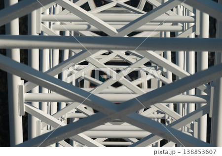 Intricate patterns of white lattice create a mesmerizing perspective from above on a sunny day Intricate patterns of white lattice create a mesmerizing perspective from above on a sunny day 138853607