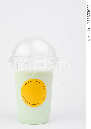 Creamy mint shake in a clear cup boasts a bright yellow label, perfect for refreshing sips on a warm afternoon at a trendy fast food spot Creamy mint shake in a clear cup boasts a bright yellow label, perfect for refreshing sips on a warm afternoon at a trendy fast food spot 138853696