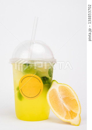 Refreshing citrus drink served in a clear cup with a lemon slice and mint leaves, perfect for summer days and delightful gatherings Refreshing citrus drink served in a clear cup with a lemon slice and mint leaves, perfect for summer days and delightful gatherings 138853702