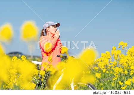woman suffering from pollen allergy while  training outdoors 138854681
