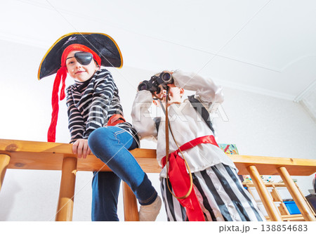 Children playing pirates in costume at home interior 138854683