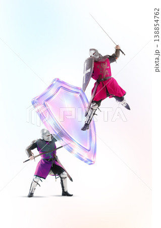 Two medieval knights fighting with holographic shields symbolizing cybersecurity competition. 138854762