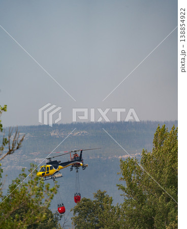 Helicopter Efforts in Fighting Forest Fire from Above Helicopter Efforts in Fighting Forest Fire from Above 138854922