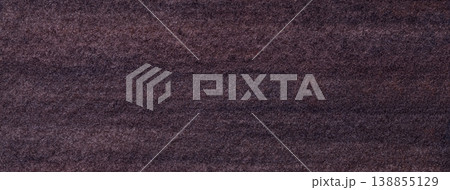 Dark brown textured paper background with subtle grain surface and soft structure. Chocolate backdrop, macro 138855129