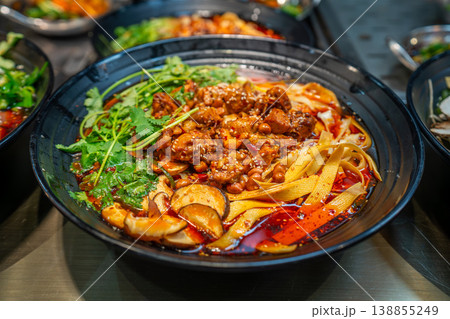 Local food and snacks including pork, Scallion Oil Noodles, intestines and seafood brochettes displayed in a popular market at night, Shanghai, China. 138855249