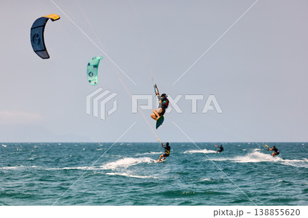 Nha Trang, Khanh Hoa, Vietnam - April 5, 2026: Multiple Kitesurfers Performing Big Air Jumps Over Sea 138855620