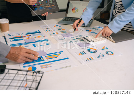Teamwork process, Business team using a calculator to calculate the numbers of statistic business profits growth rate on documents graph data, desk in the office. 138857148