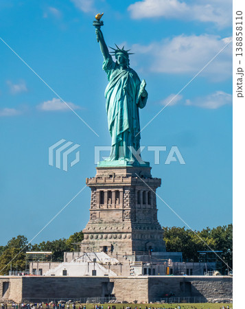 World famous Statue of Liberty under a blue sky with white clouds 138858110