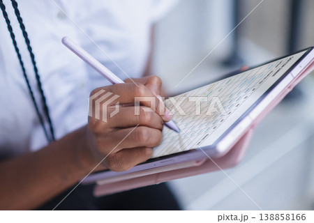 Close up of hand using stylus on tablet with digital planner interface. Schedule management, note taking, online organization, remote work, data entry and productivity concept. Close up of hand using stylus on tablet with digital planner interface. Schedule management, note taking, online organization, remote work, data entry and productivity concept. 138858166