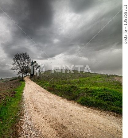 Dramatic sky over a dirt road in Tuscany 138858511