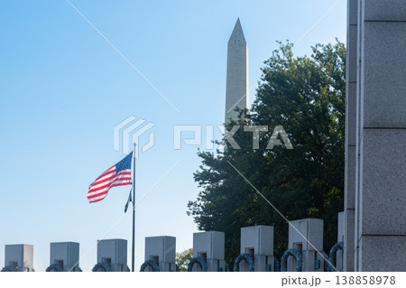 American Flag with Washington Monument Viewed from the National World War II Memorial American Flag with Washington Monument Viewed from the National World War II Memorial 138858978