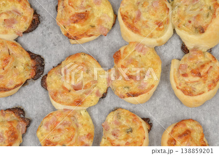 Baked puff pastry rolls with cheese cream, cheese and ham 138859201
