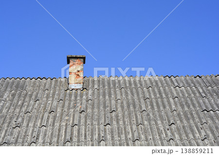 Old Brick Chimney on Asbestos Tile Roof 138859211