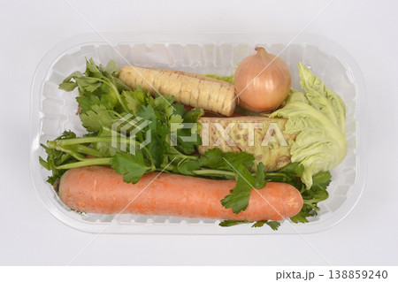 Fresh soup vegetables in plastic container on white background Fresh soup vegetables in plastic container on white background 138859240