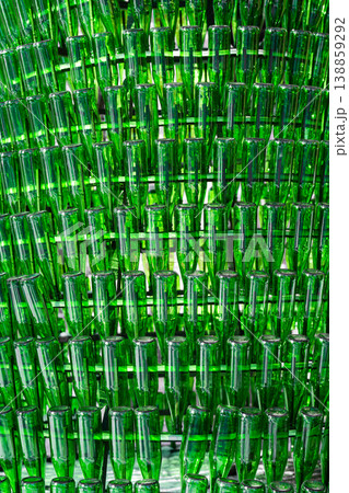 Background of empty green glass bottles. Vertical shot . Background of empty green glass bottles. Vertical shot . 138859292