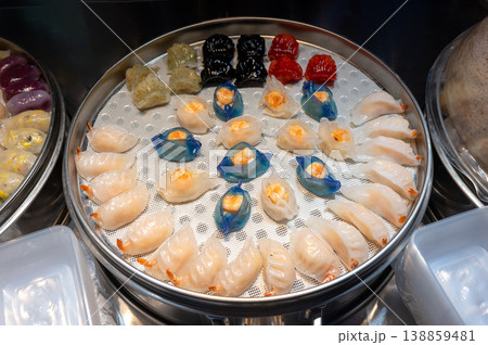 Colorful Assortment of Dim Sum in a Steamer Basket at a Vibrant Asian Night Food Market 138859481