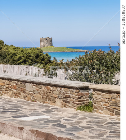 Aragonese tower of La Pelosa Beach seen from the sidewalk along the shore, Sardinia 138859837