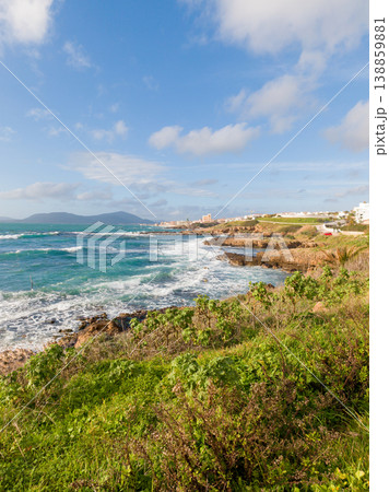Rough Sea Along the Coast of Alghero Under a Blue Sky with White Clouds 138859881