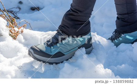 Close Up of a Hiking Boot Stepping on Snow 138859882