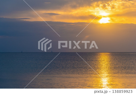 Sunset Over the Sea with Distant Boats on the Horizon 138859923
