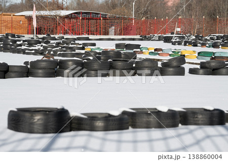 Old tires on a kart racing track . Racetrack fence Old tires on a kart racing track . Racetrack fence 138860004