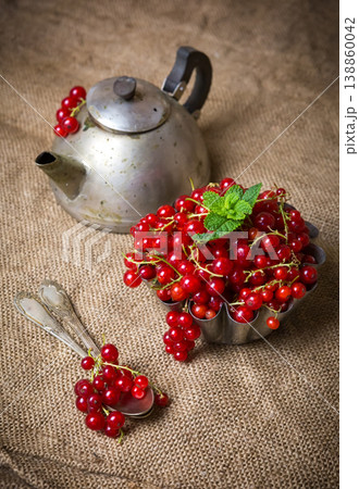 juicy currant berries on burlap near an old teapot juicy currant berries on burlap near an old teapot 138860042