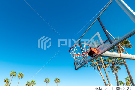 Basketball Hoop with Palm Trees Under Blue Sky in California 138860129